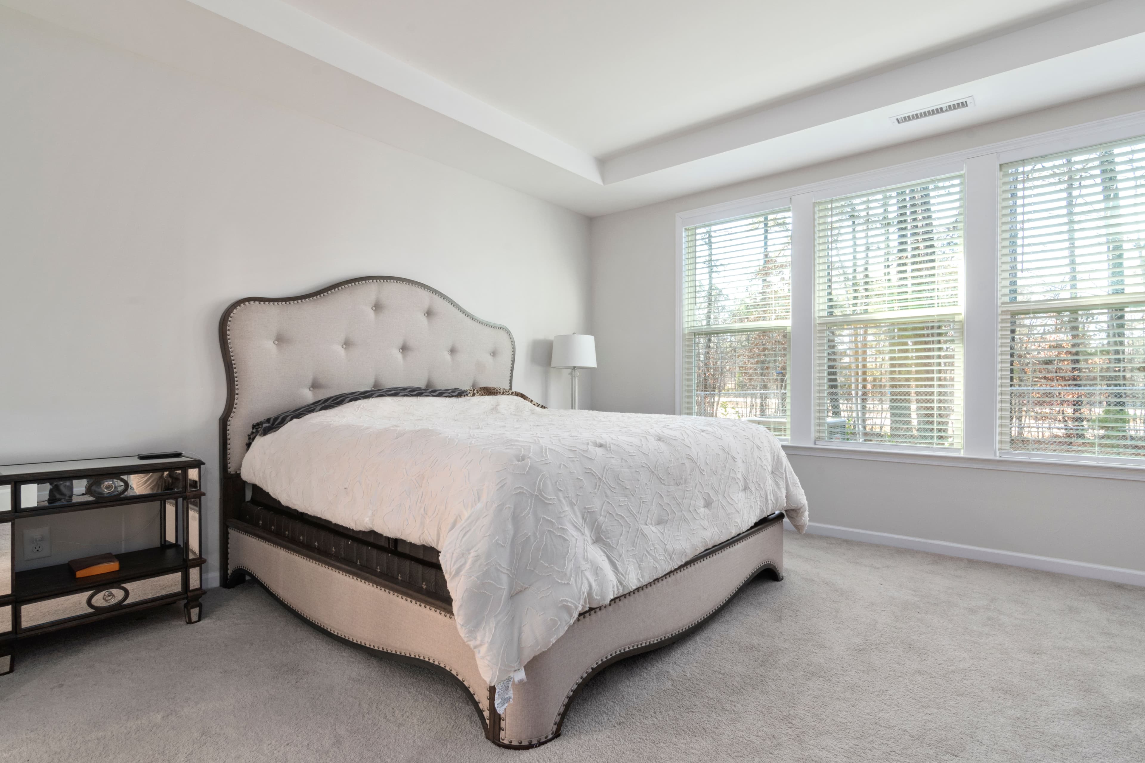 Prepared bedroom with fresh linen and thoughtful furnishing